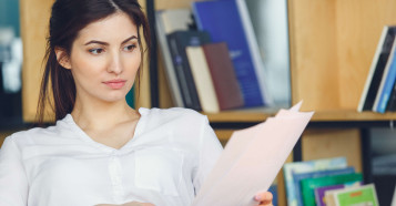 woman sitting reading documents